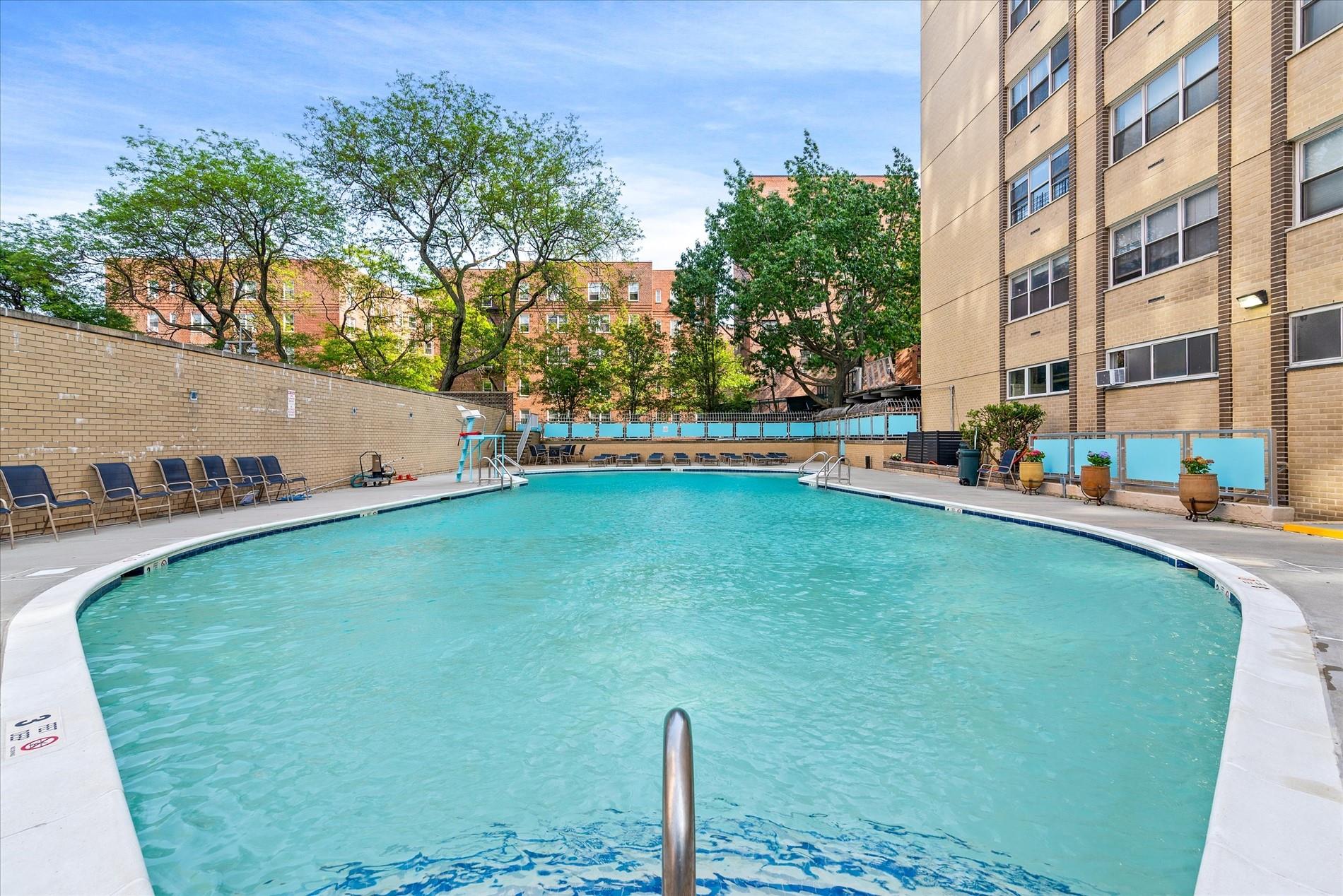102-30 66th Road, Unit 4B Queens, NY 11375 - Photo 21 of 26 a swimming pool with outdoor seating and yard