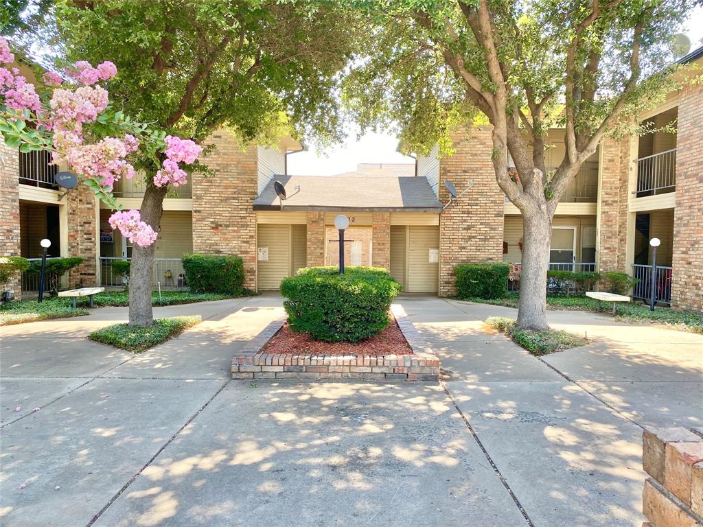 222 North Center Street, Unit 106 Grand Prairie, TX 75050 - Photo 2 of 8 a view of a street with a house in the background