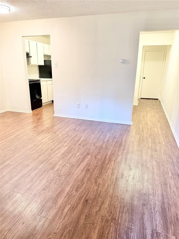222 North Center Street, Unit 106 Grand Prairie, TX 75050 - Photo 3 of 8 a view of a kitchen with wooden floor and a sink