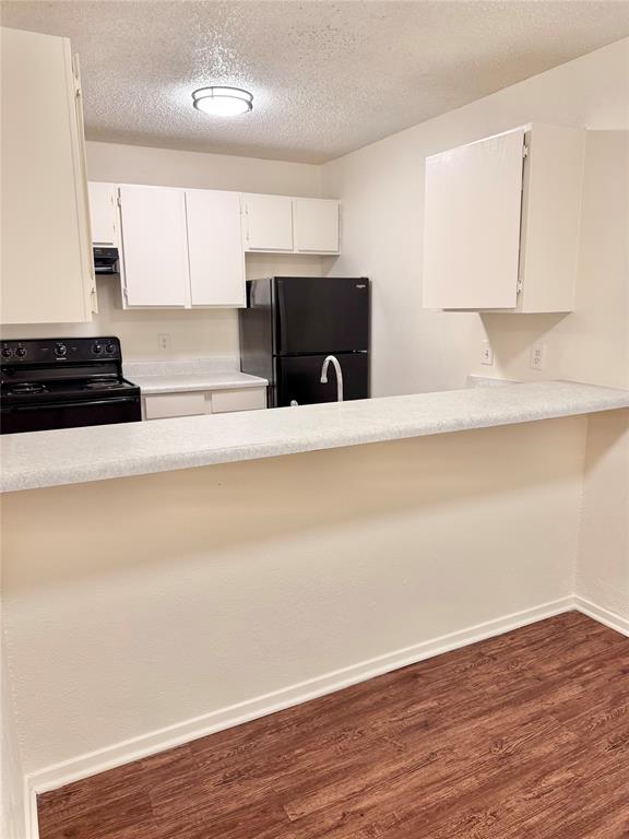 222 North Center Street, Unit 106 Grand Prairie, TX 75050 - Photo 6 of 8 a kitchen with granite countertop a stove and a refrigerator