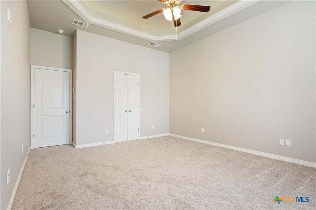 4 Salta Court Belton, TX 76513 - Photo 26 of 45 an empty room with a chandelier fan and windows