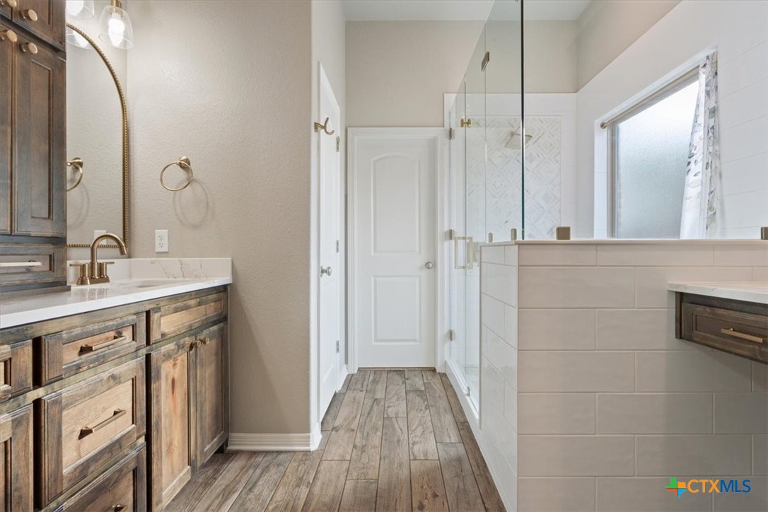 4 Salta Court Belton, TX 76513 - Photo 27 of 45 a spacious bathroom with a double vanity sink a mirror and shower
