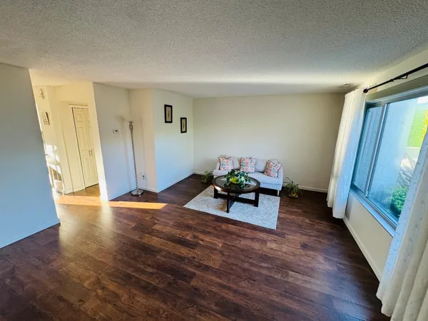 a view of a room with wooden floor and furniture