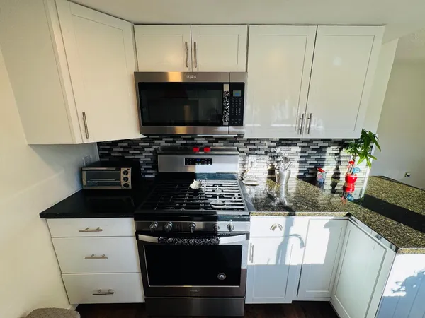 a kitchen with a stove and a microwave