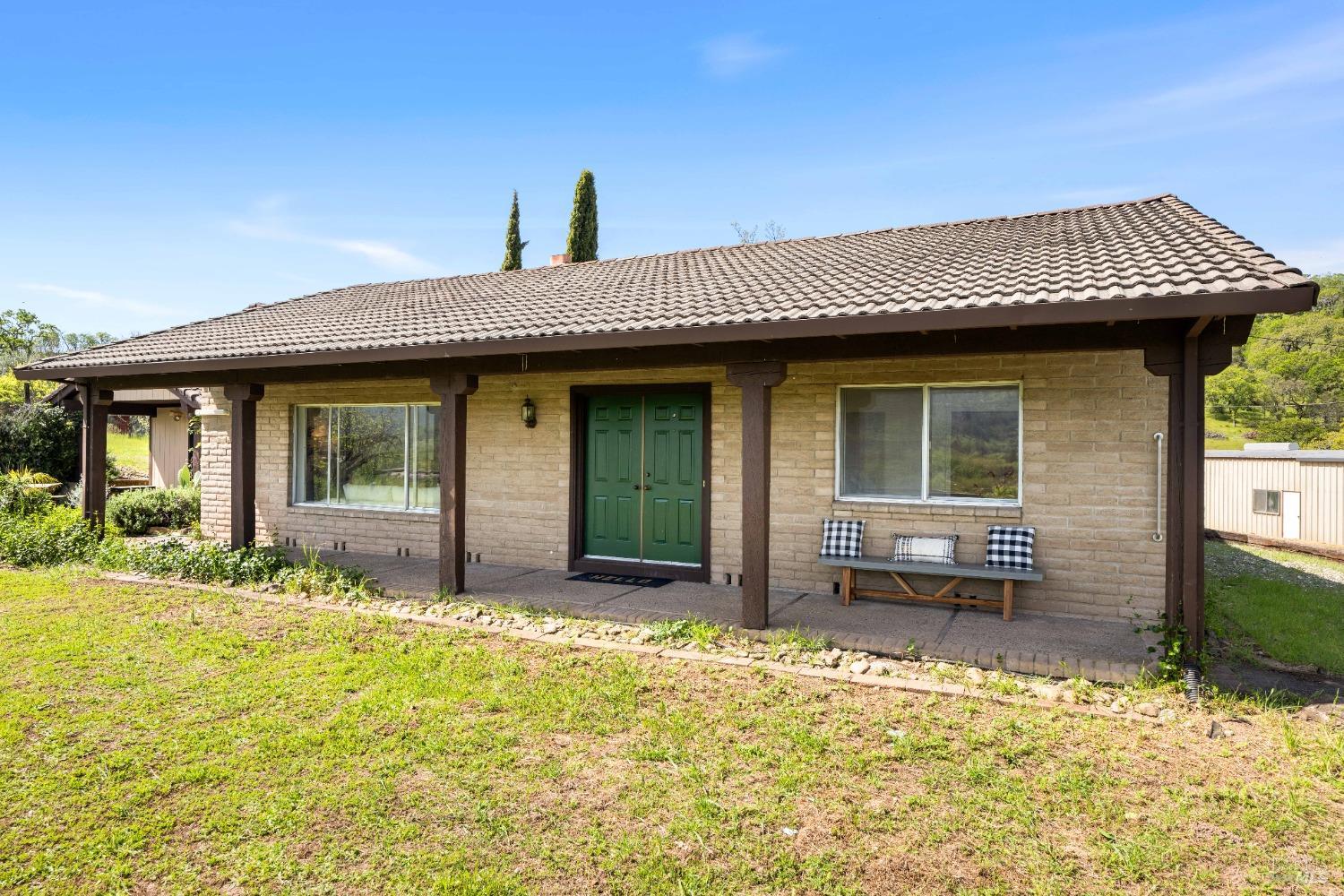 12600 Henno Road Glen Ellen, CA 95442 - Photo 7 of 45 a view of a house with large windows and a yard