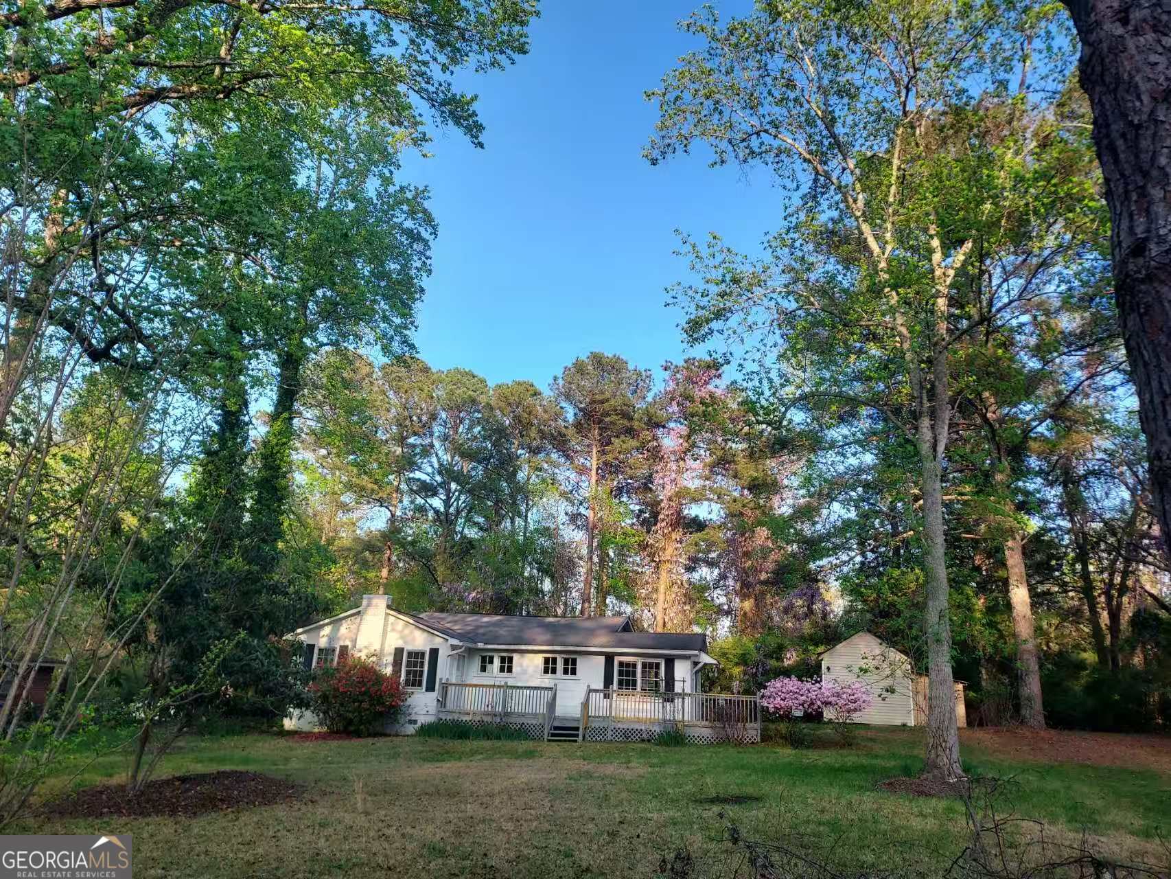 a view of house with garden space and trees