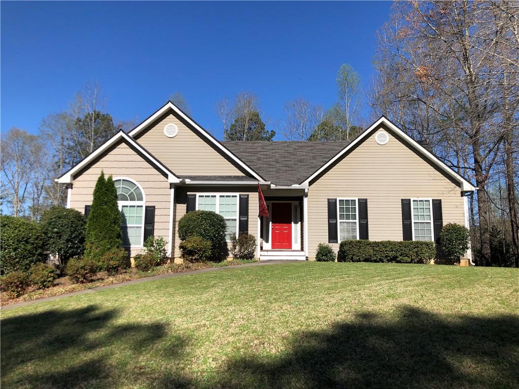 a front view of house with yard and outdoor seating