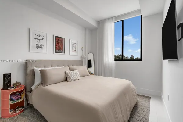 a bedroom with bed and tv