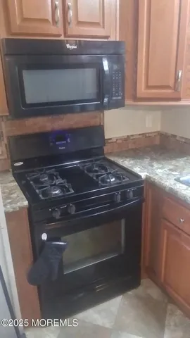 a stove top oven sitting inside of a kitchen
