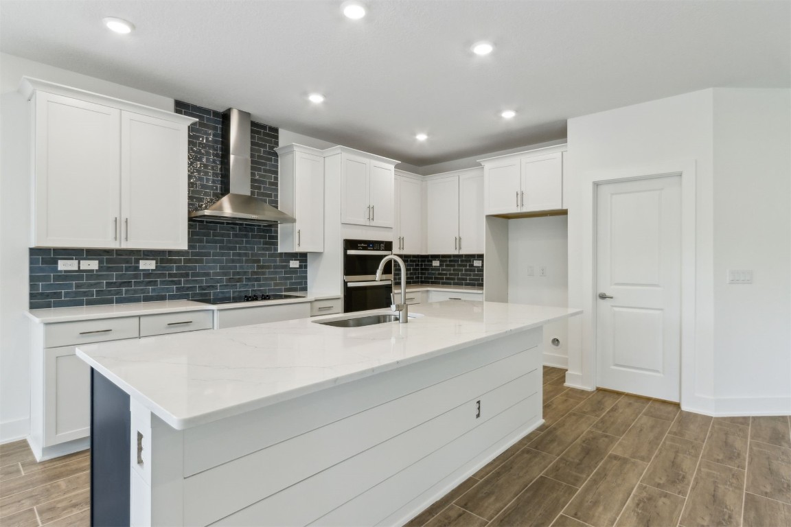 96100 Pirates Bluff Road Yulee, FL 32097 - Photo 12 of 39 a kitchen with a sink white cabinets and white appliances
