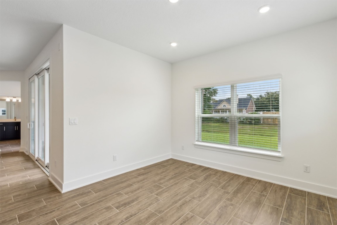96100 Pirates Bluff Road Yulee, FL 32097 - Photo 14 of 39 an empty room with wooden floor and windows