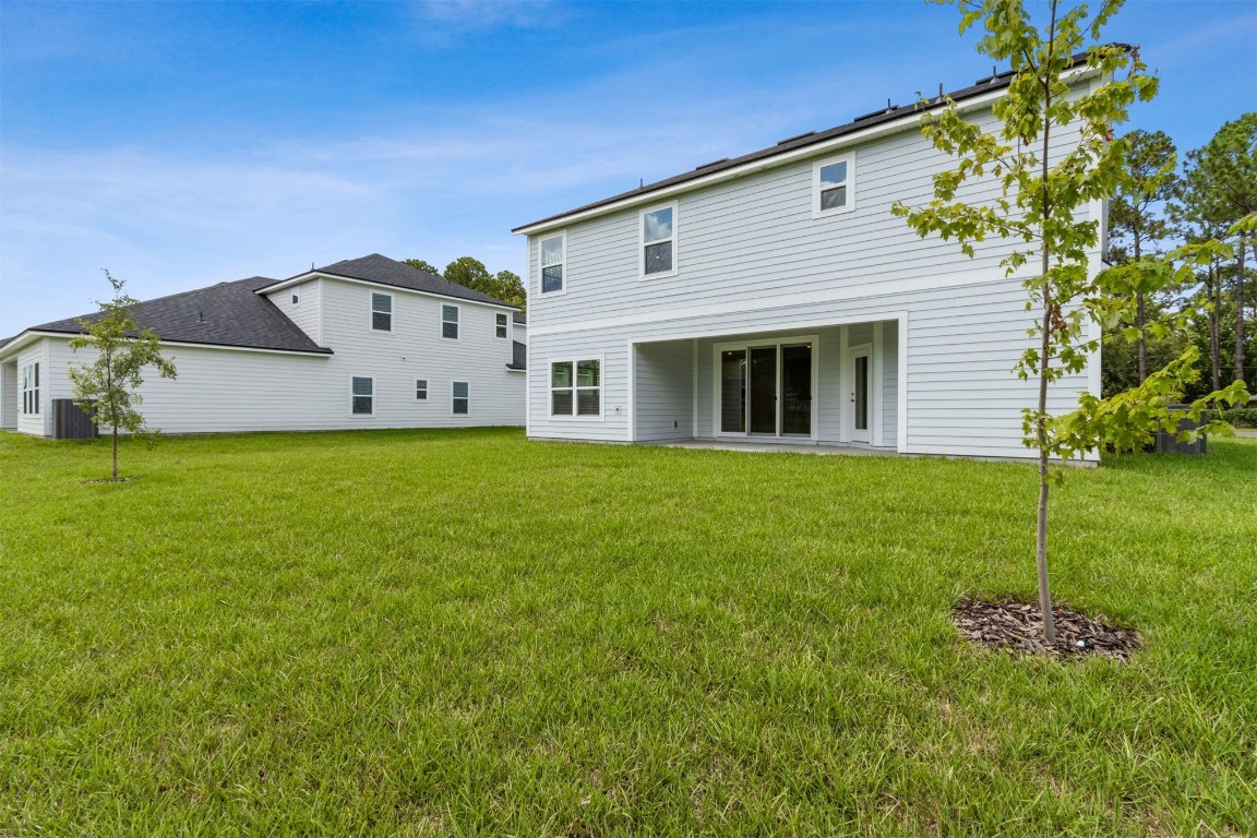 96100 Pirates Bluff Road Yulee, FL 32097 - Photo 37 of 39 a view of a house with a yard