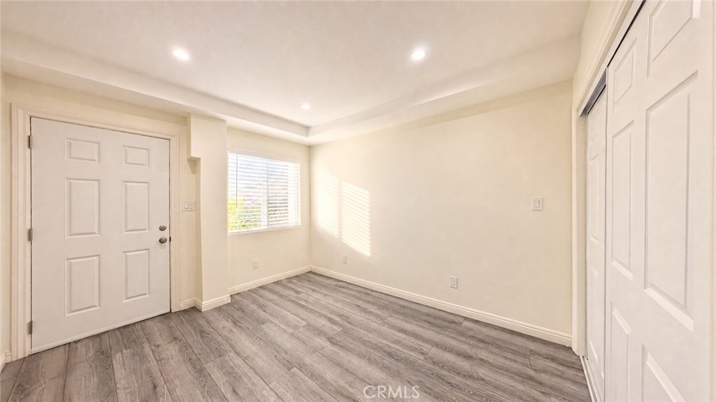 6851 Foothill Boulevard Tujunga, CA 91042 - Photo 38 of 50 an empty room with wooden floor and windows