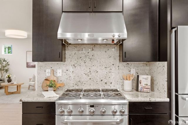 a stove top oven sitting inside of a kitchen