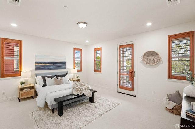 a bedroom with furniture and a window