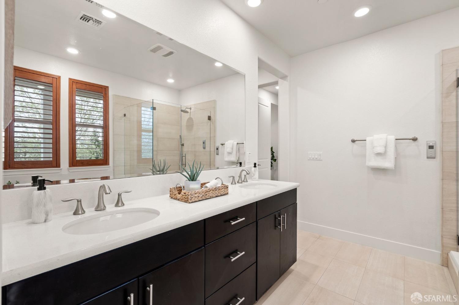 1552 Clement Avenue Alameda, CA 94501 - Photo 14 of 23 a bathroom with double vanity sinks double vanity tub and a mirror