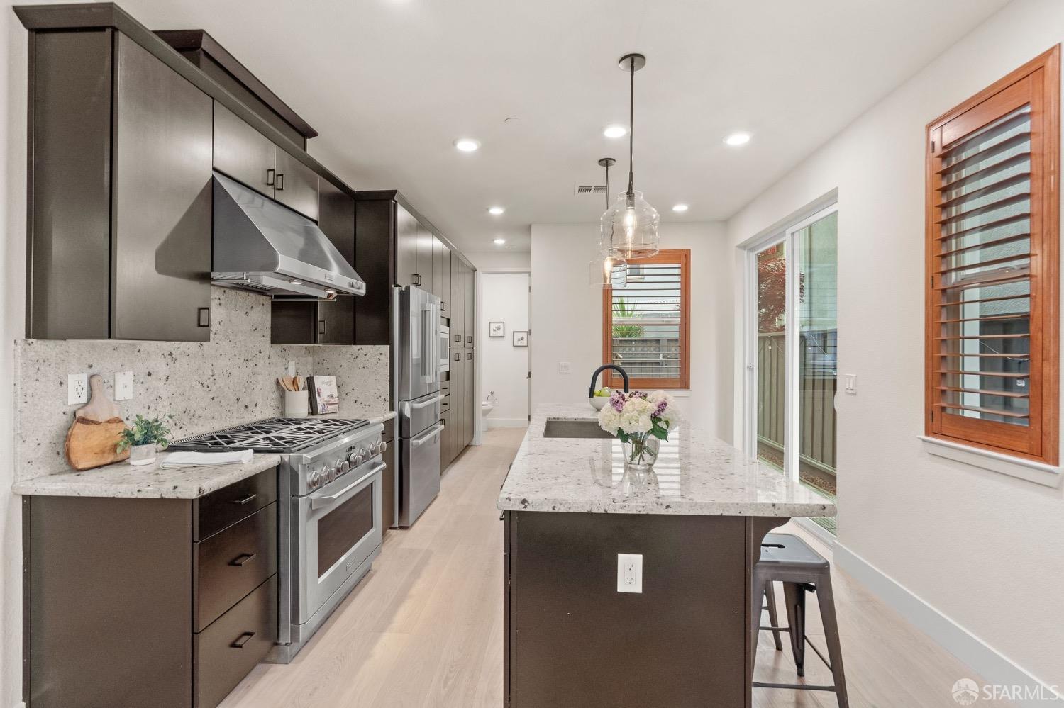 1552 Clement Avenue Alameda, CA 94501 - Photo 8 of 23 a kitchen with stainless steel appliances granite countertop stove microwave and refrigerator