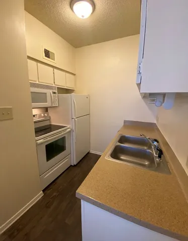 a kitchen with a stove and a microwave