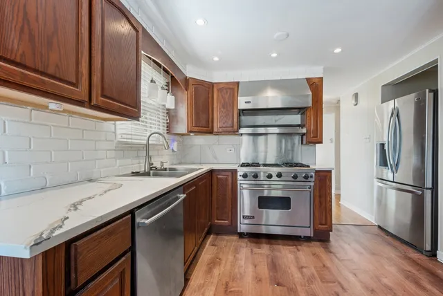 a kitchen with a sink stove and refrigerator