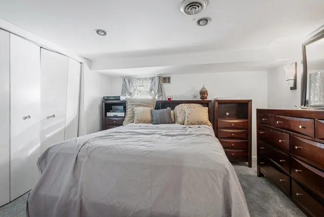 a bedroom with a bed and dresser