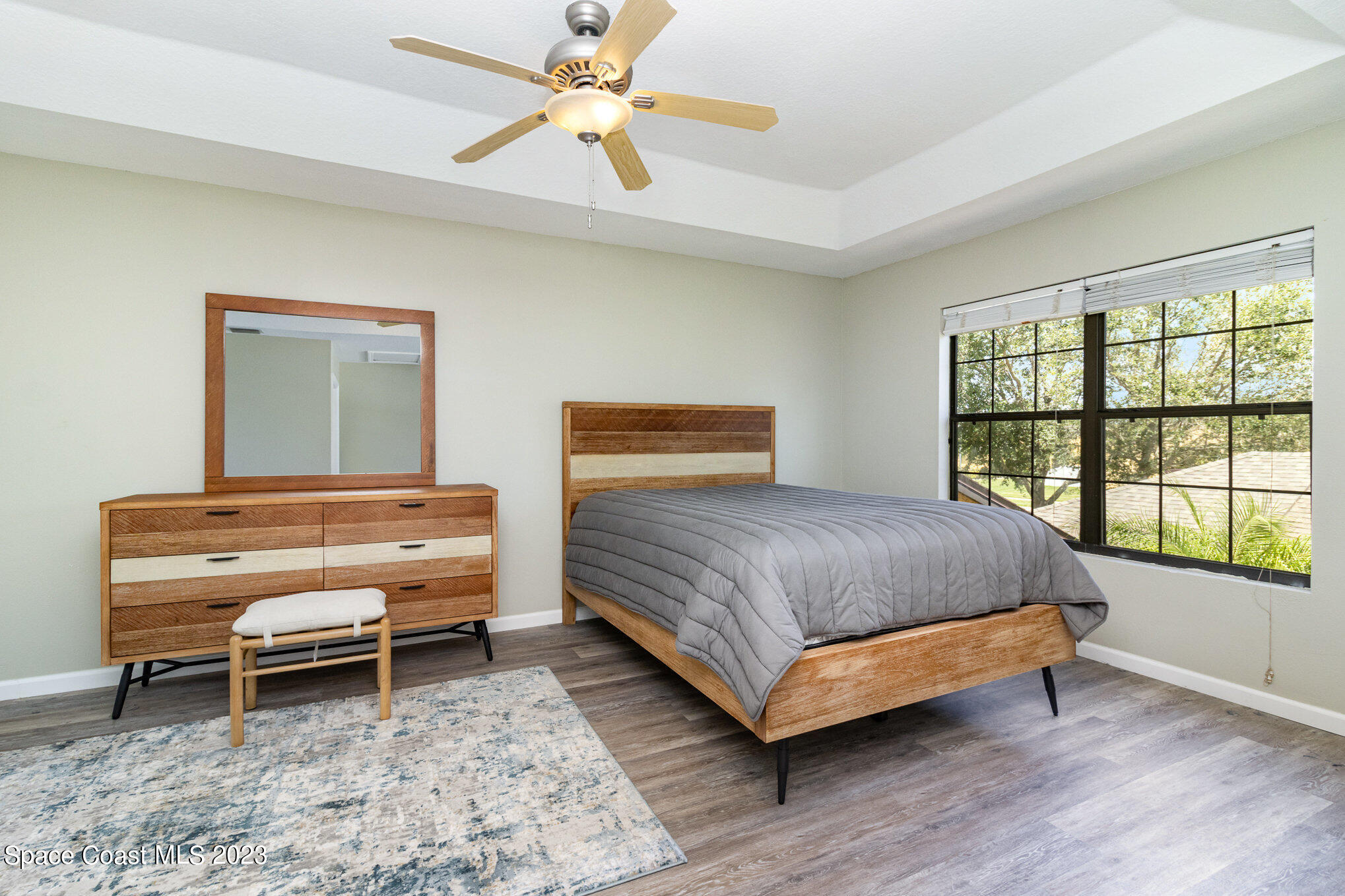 950 Luminary Circle, Unit 103 Melbourne, FL 32901 - Photo 13 of 23 a bedroom with a bed and a window