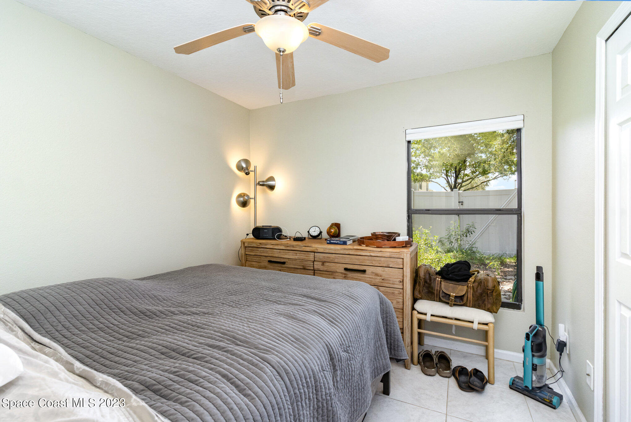 950 Luminary Circle, Unit 103 Melbourne, FL 32901 - Photo 18 of 23 a bedroom with a bed and a chandelier