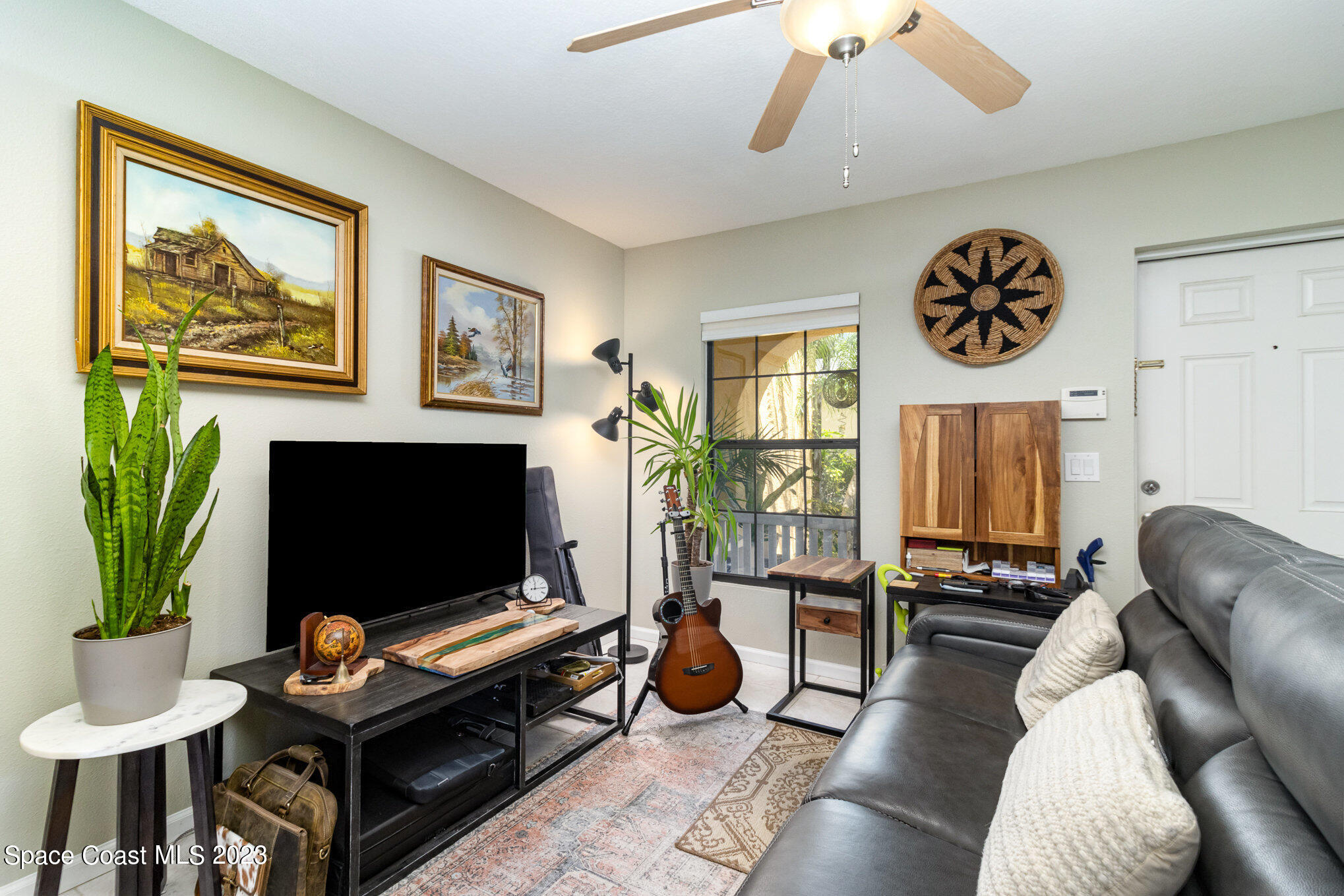 950 Luminary Circle, Unit 103 Melbourne, FL 32901 - Photo 4 of 23 a living room with furniture and a flat screen tv