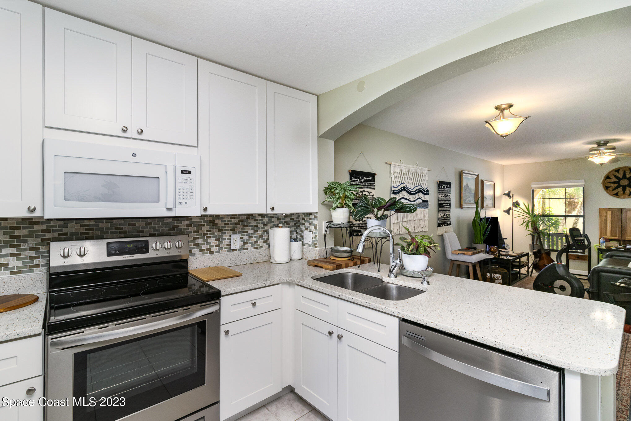 950 Luminary Circle, Unit 103 Melbourne, FL 32901 - Photo 7 of 23 a kitchen with a sink stove and cabinets
