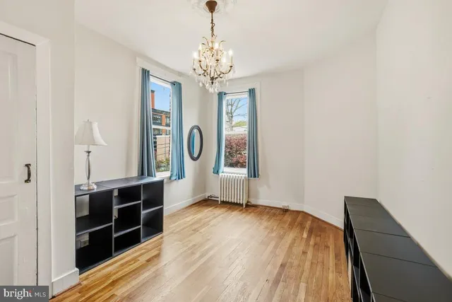 a view of a room with wooden floor and windows
