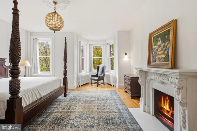 a bedroom with furniture and a fireplace