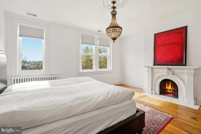 a bedroom with a bed and a fireplace