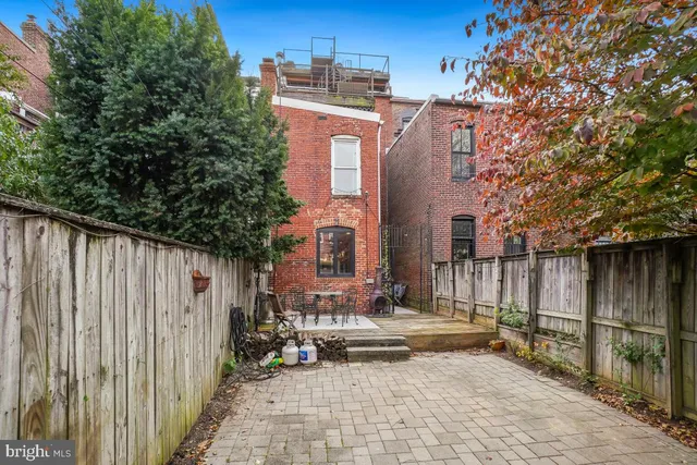 a view of a patio with table and chairs and potted plants