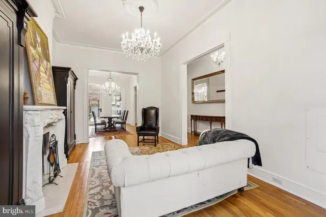a living room with fireplace furniture and a chandelier