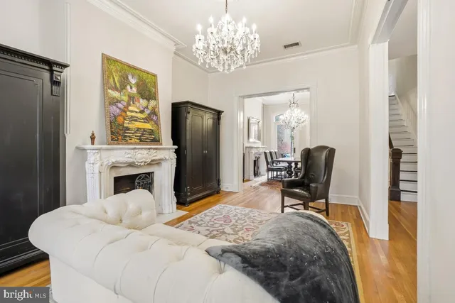a bedroom with a bed dresser and a large mirror next to a window