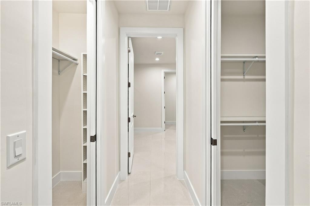 Hallway featuring recessed lighting, light-toned walls, and a light tile floor