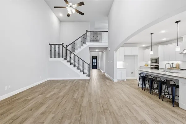 a view of a room with wooden floor and staircase