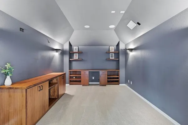 a view of an empty room with furniture and stairs