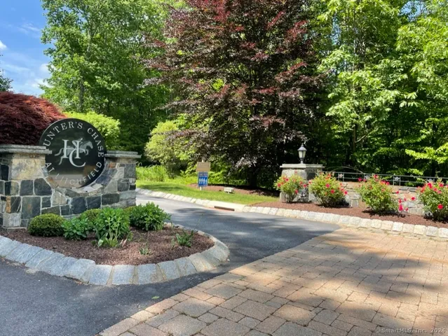 a view of a house with a yard and a garden