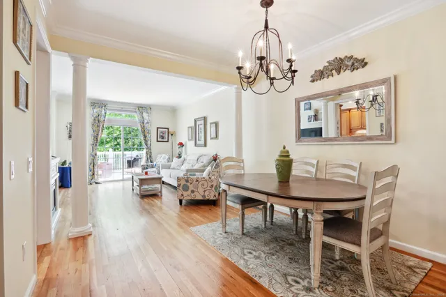 a view of a dining room with furniture wooden floor and chandelier