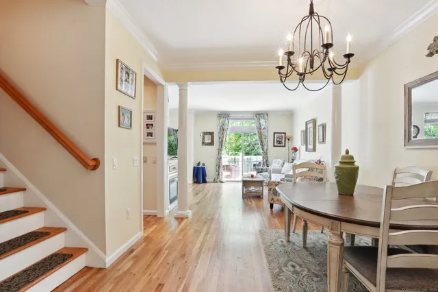 a view of a dining room with furniture wooden floor and chandelier