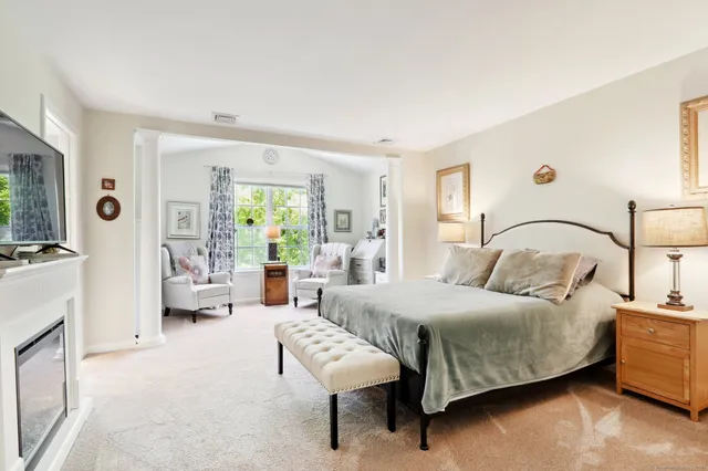 a bedroom with a bed a couch and dresser