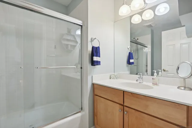 a bathroom with a bathtub sink and mirror