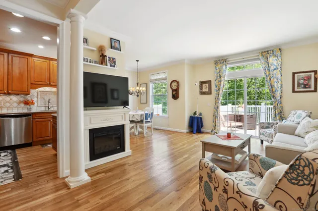 a living room with furniture fireplace and flat screen tv