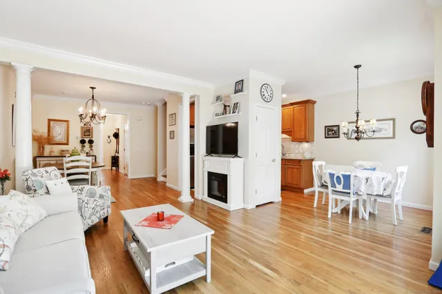 a living room with furniture wooden floor and a flat screen tv