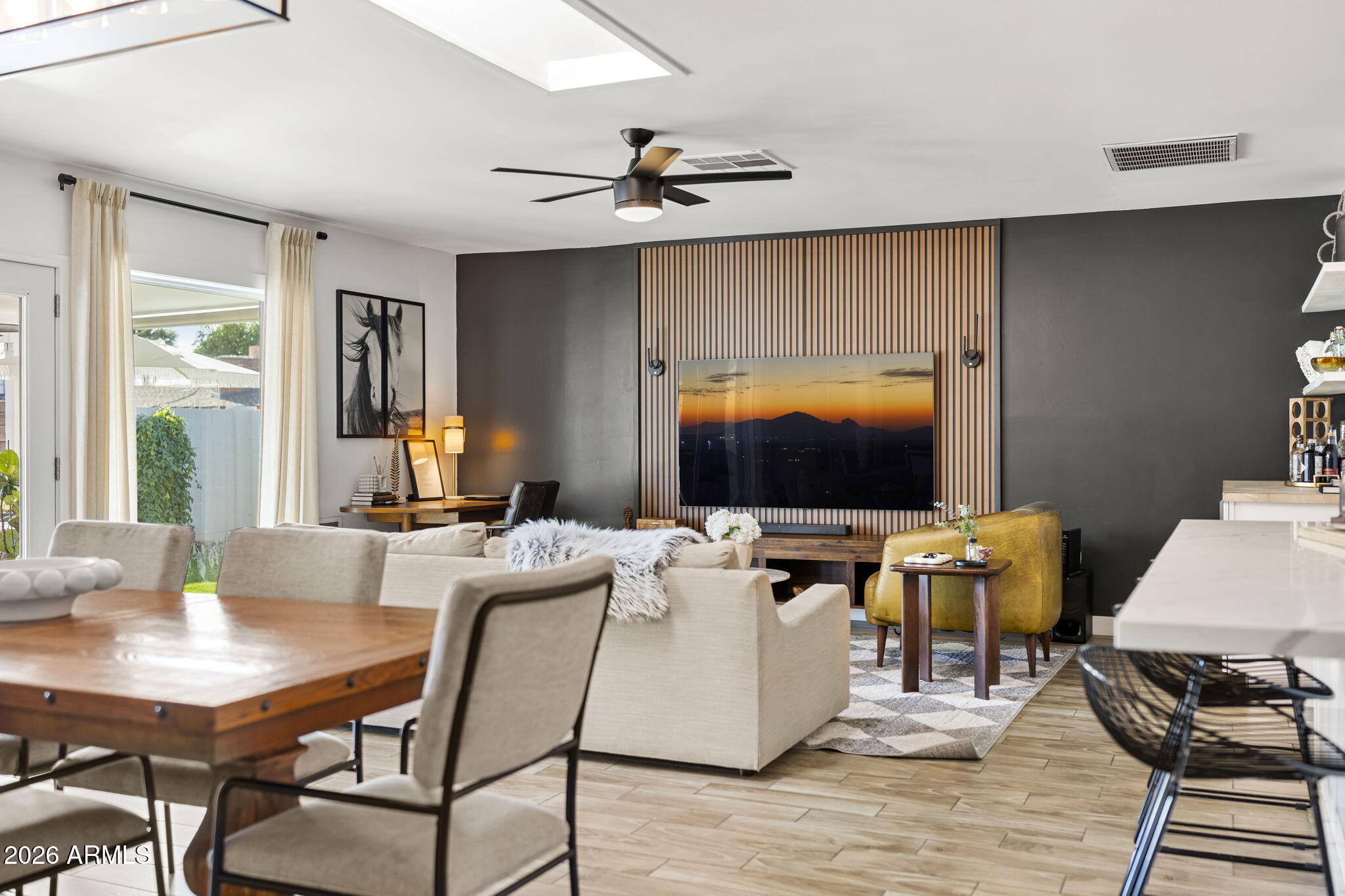 4215 East Flower Street Phoenix, AZ 85018 - Photo 15 of 39 a view of a workspace with furniture and wooden floor