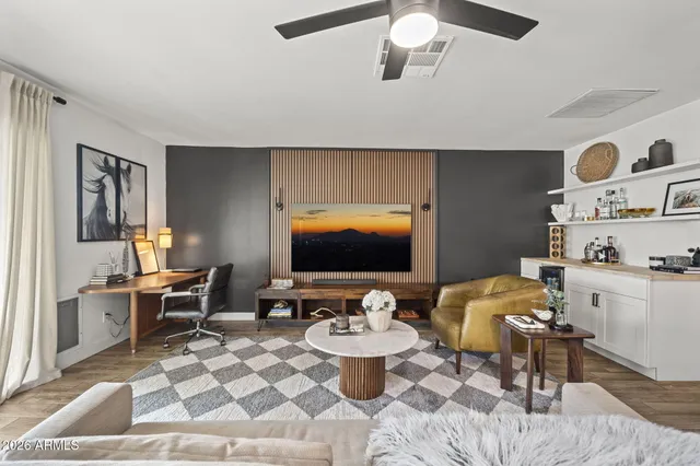 a bedroom with a bed and glass table with mirror