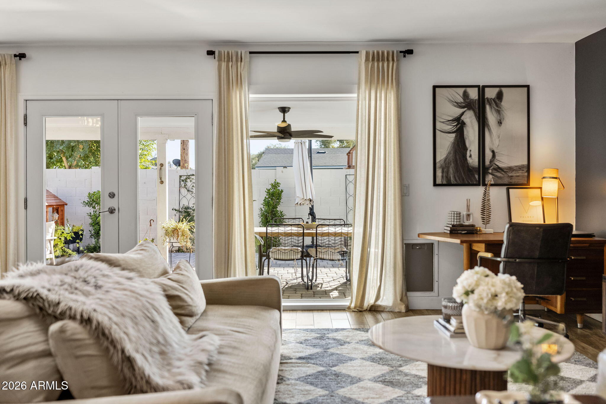 4215 East Flower Street Phoenix, AZ 85018 - Photo 19 of 39 a bedroom with a bed and glass table with mirror