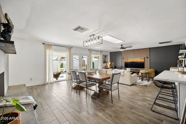 a dining room with furniture a fireplace and wooden floor