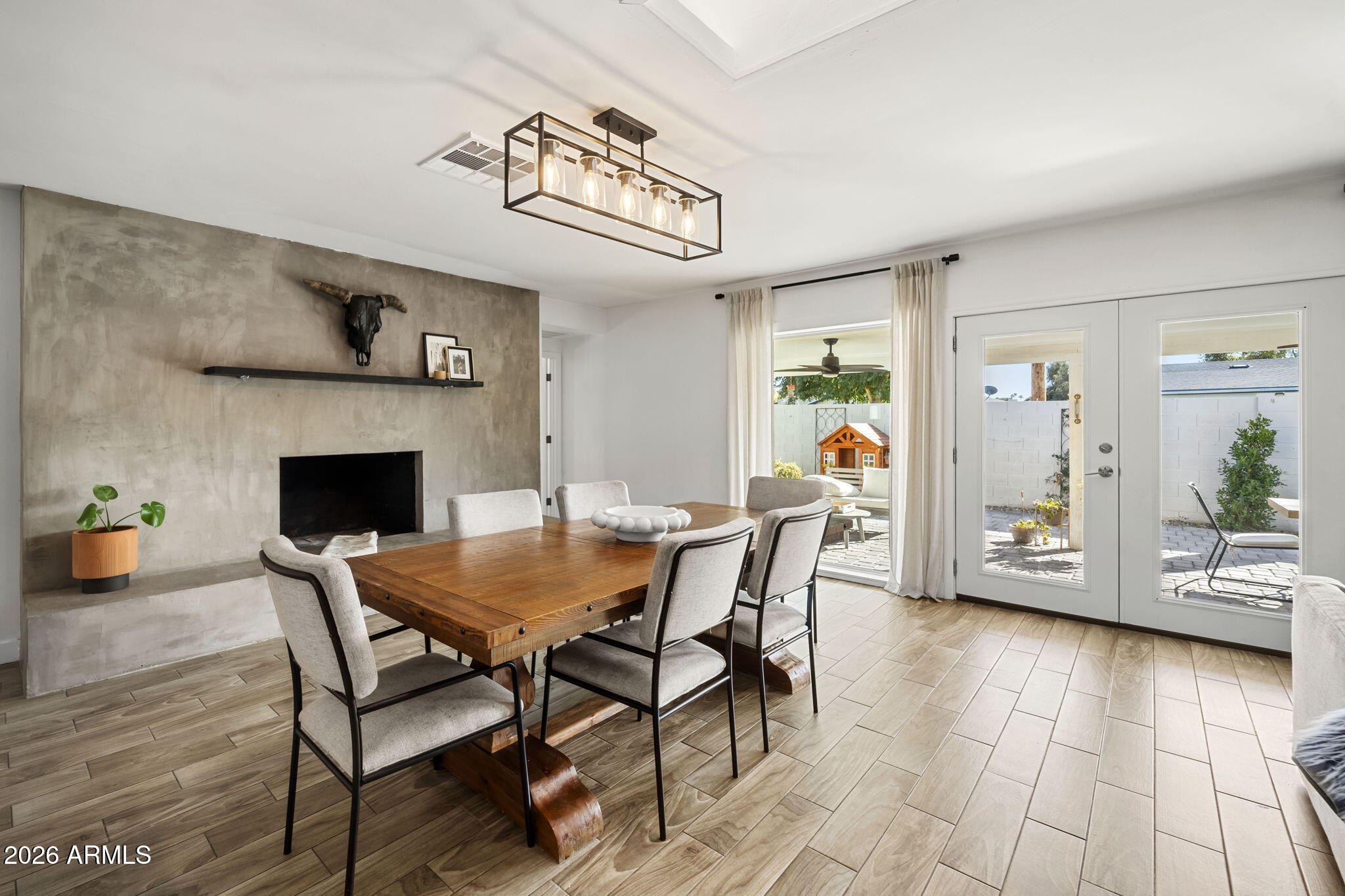 4215 East Flower Street Phoenix, AZ 85018 - Photo 22 of 39 a view of a dining room with furniture and wooden floor