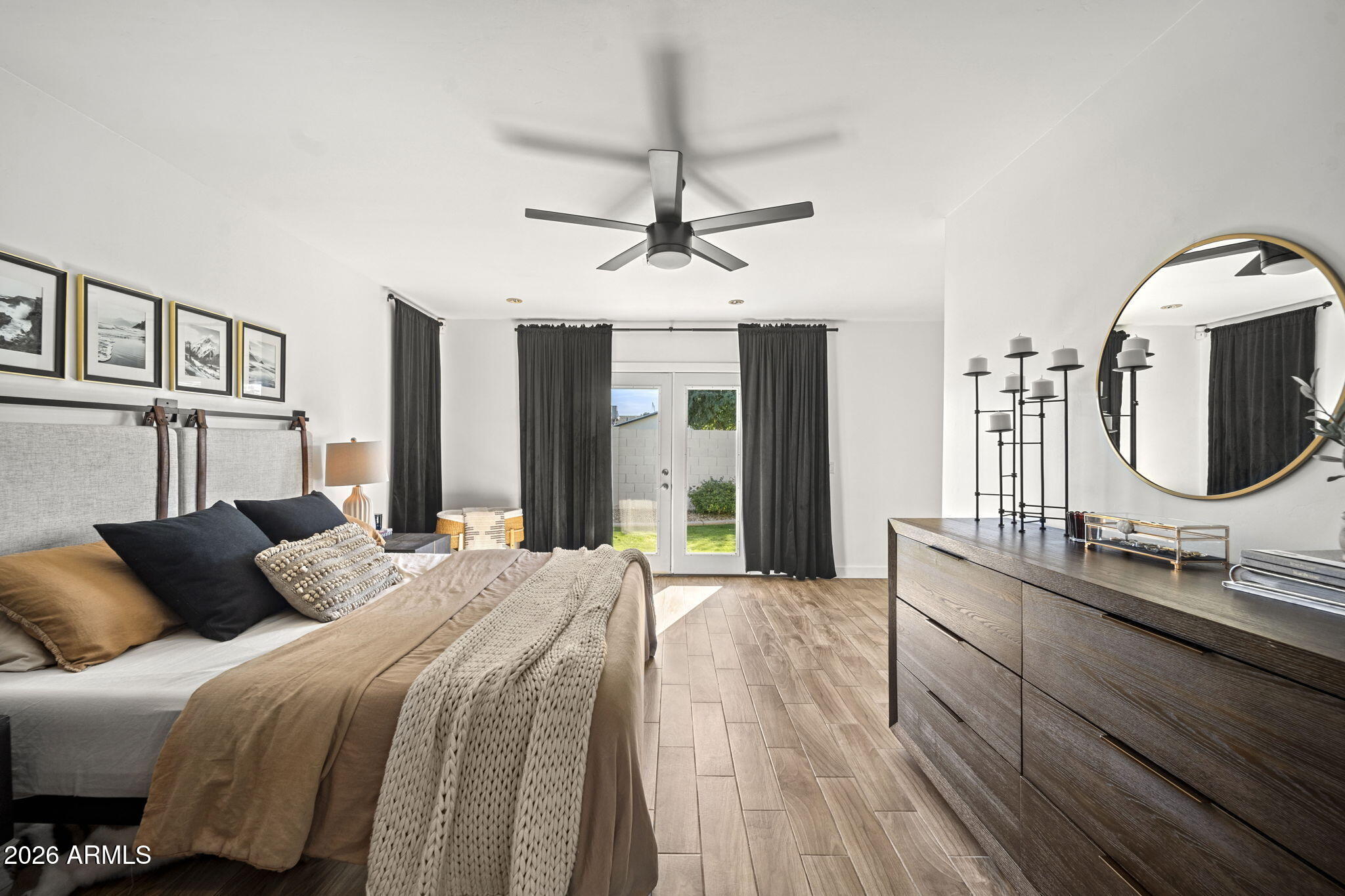 4215 East Flower Street Phoenix, AZ 85018 - Photo 23 of 39 a bedroom with a bed a mirror and windows